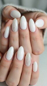 8. Milky White Nails with Glitter Accent